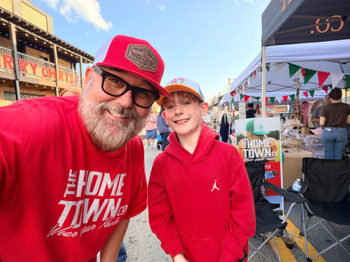 67 Drip Trucker Hat in black with white embroidered logo on front panel.