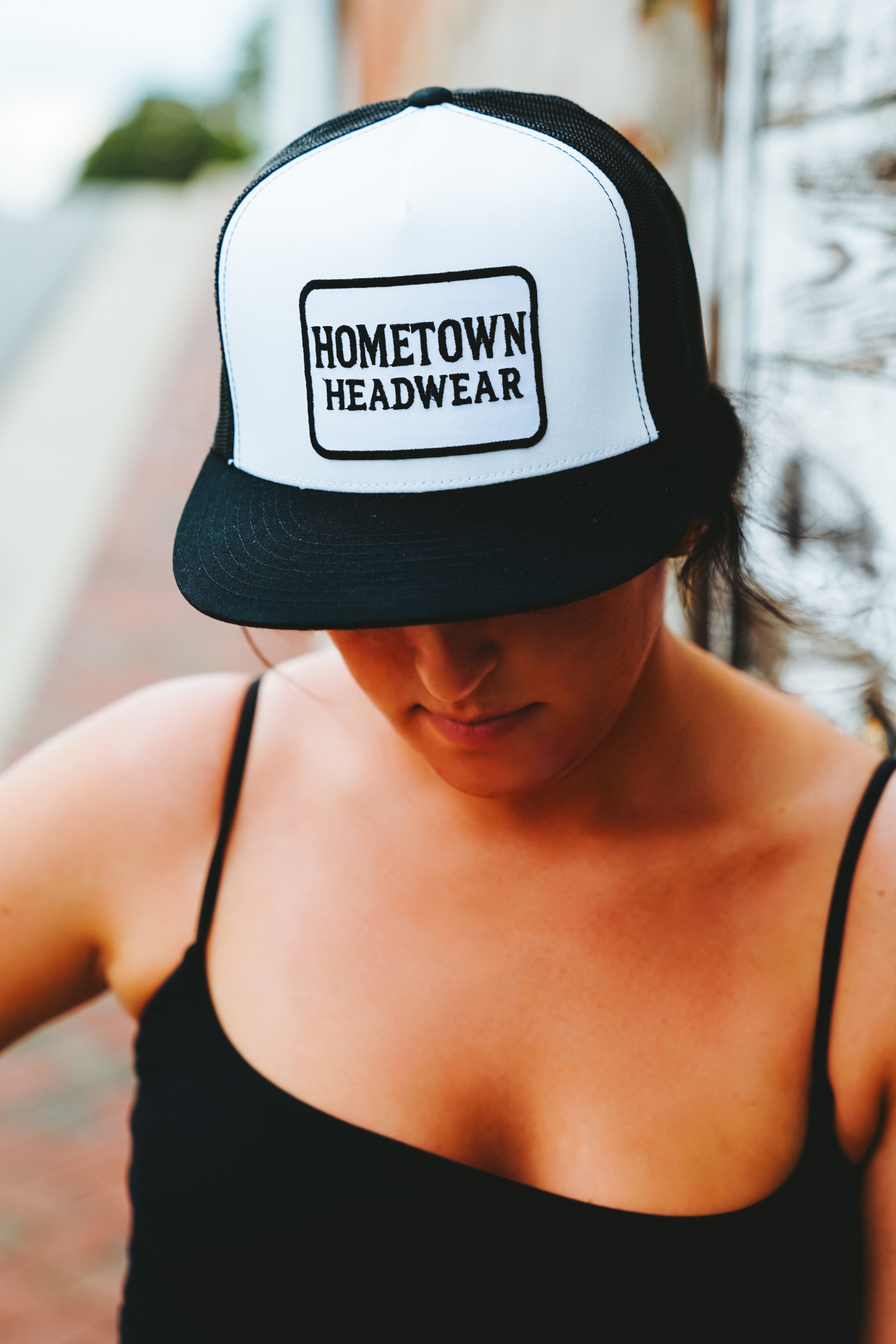 Black & White Trucker Hat with Rectangular Hometown Headwear Patch on Front.