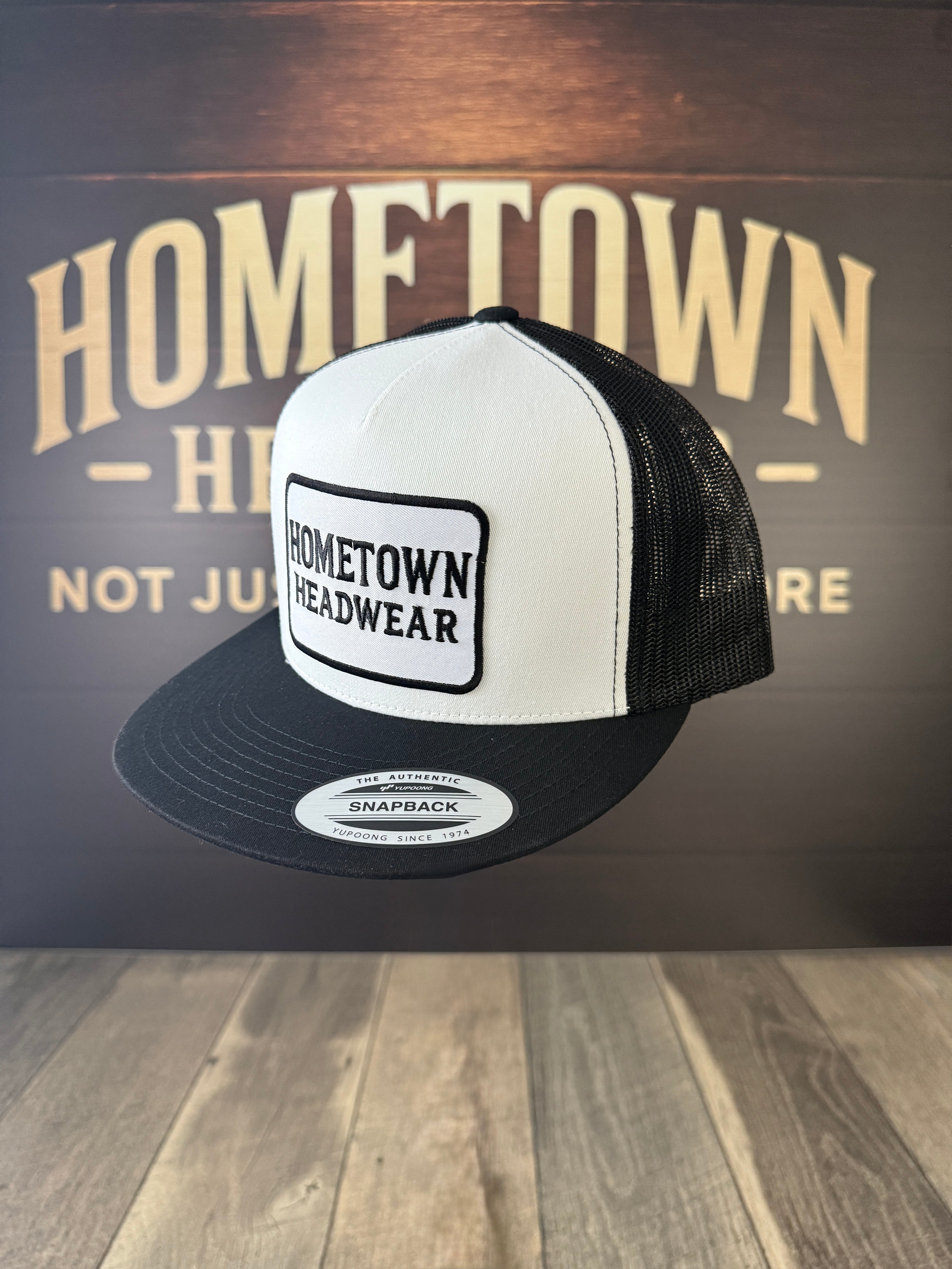 Black & White Trucker Hat with Rectangular Hometown Headwear Patch.