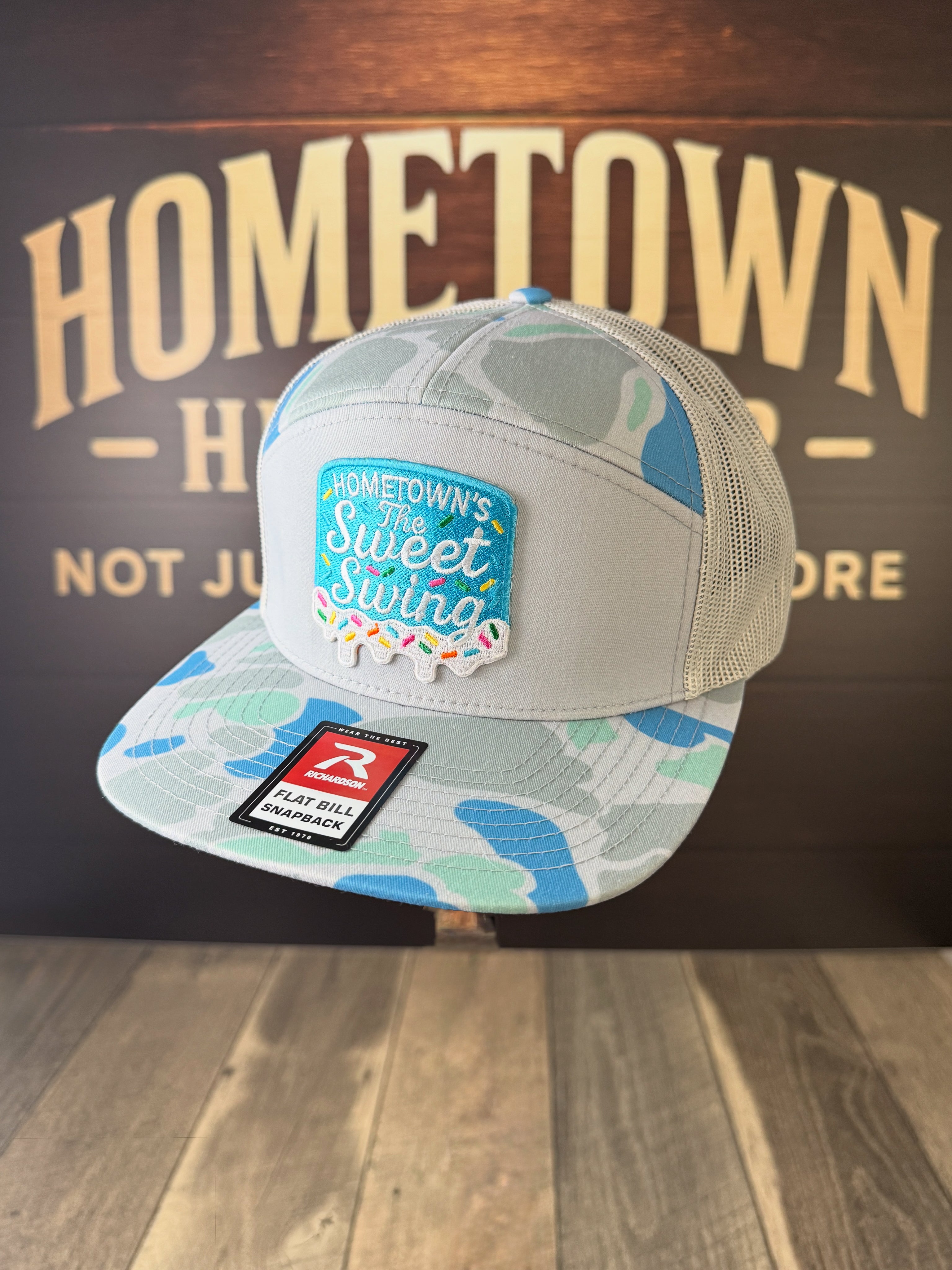 Gray-blue camo snapback hat with Sweet Swing patch from The Hometown Co.