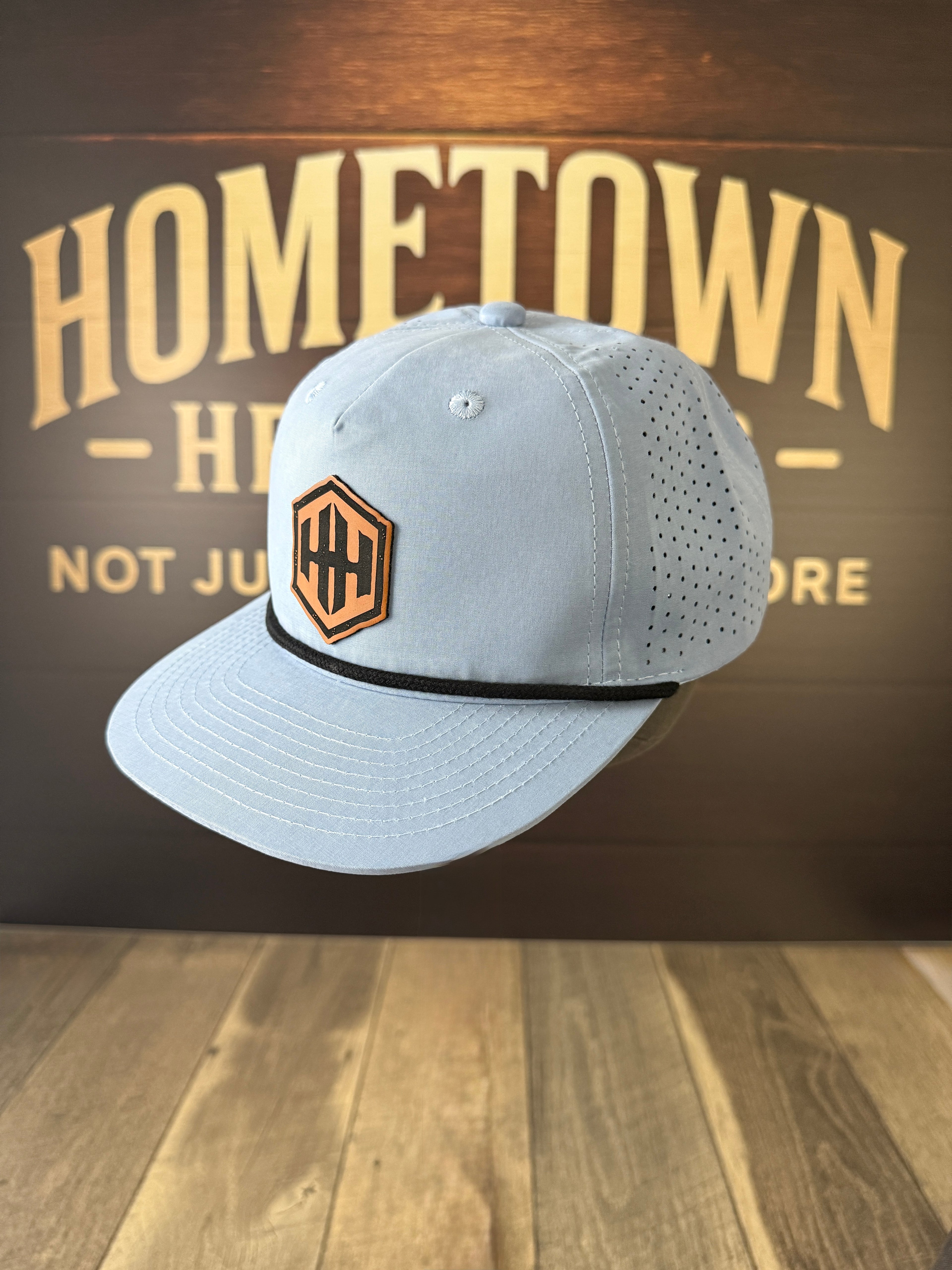 Light blue performance hat with hex leather patch, Signature Leatherette Rawhide to Black.