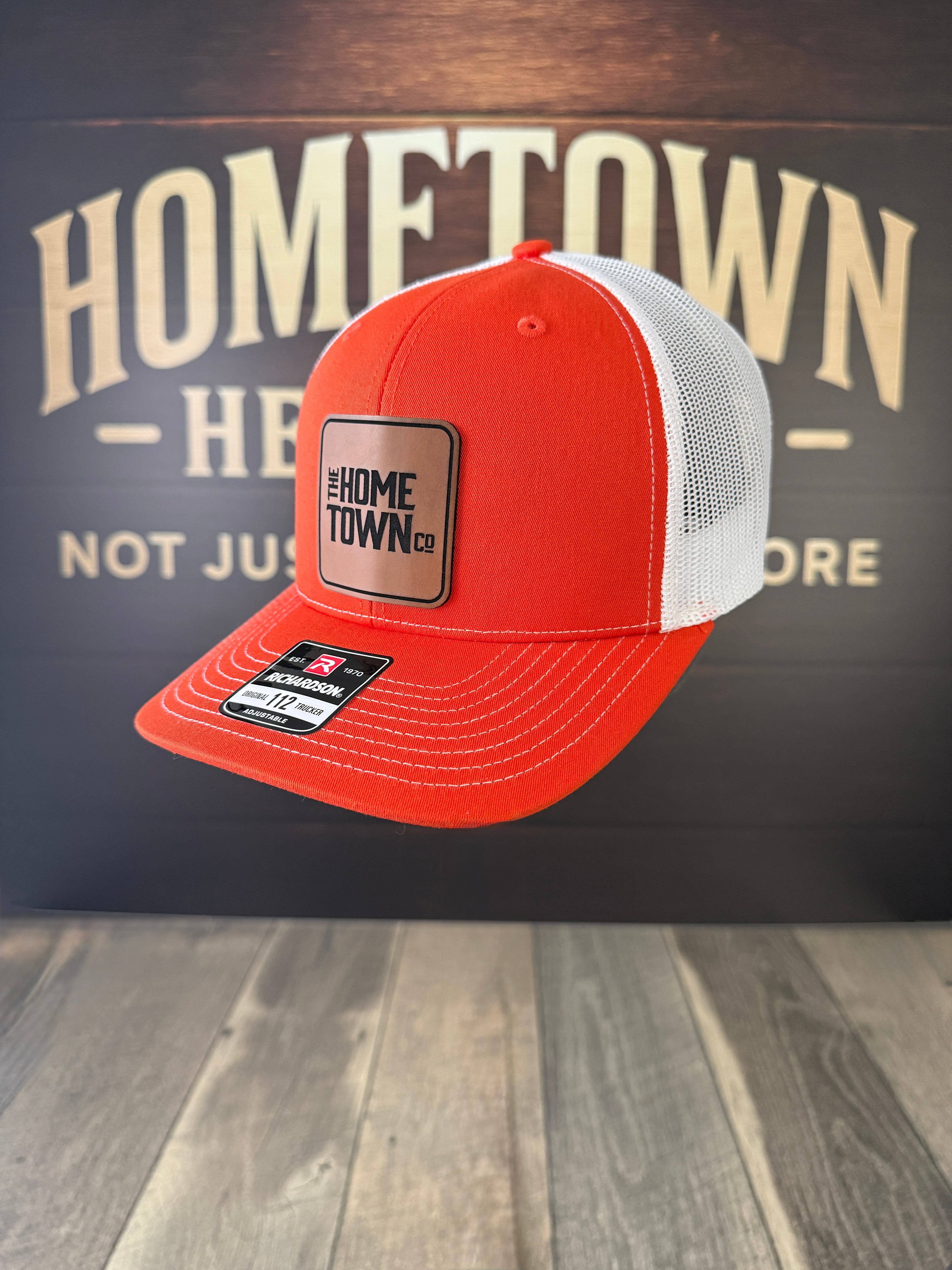 Orange-white trucker hat with square leather patch, Signature Leatherette Buckskin.